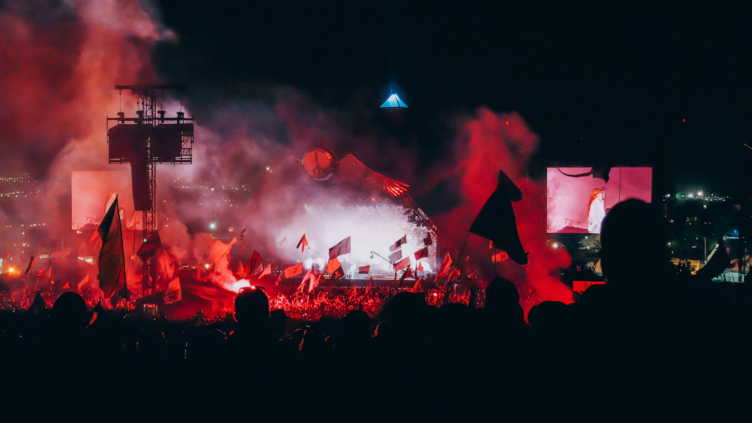 Glastonbury Pyramid Stage at night with crowd